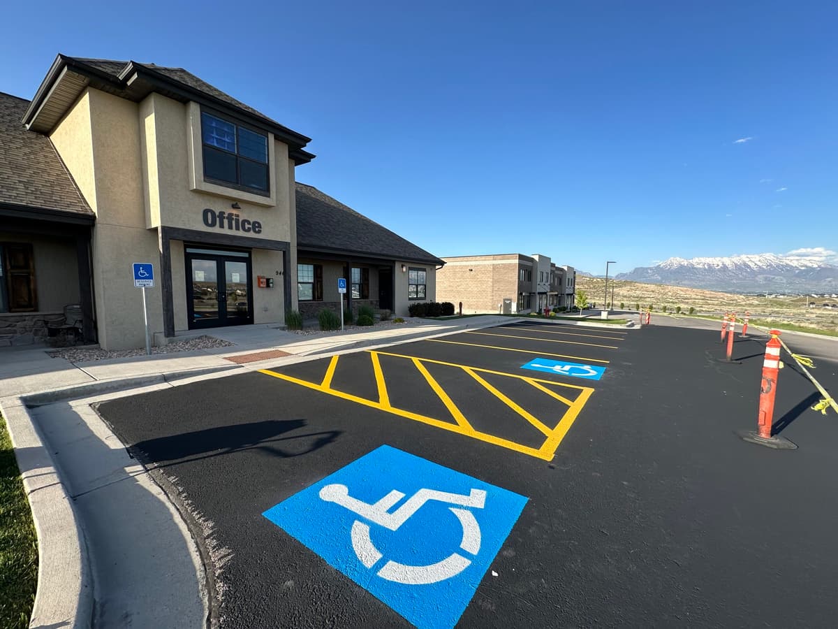 ADA compliant parking lot line striping with handicap symbols and Utah mountain backdrop by JCPM